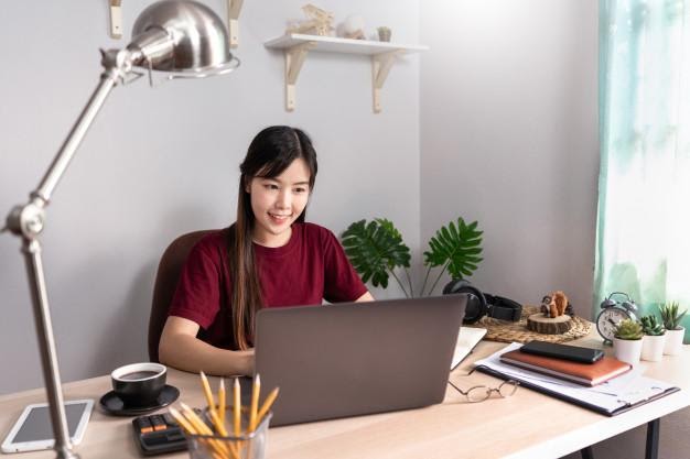 Young beautiful asian woman working at home | Premium Photo